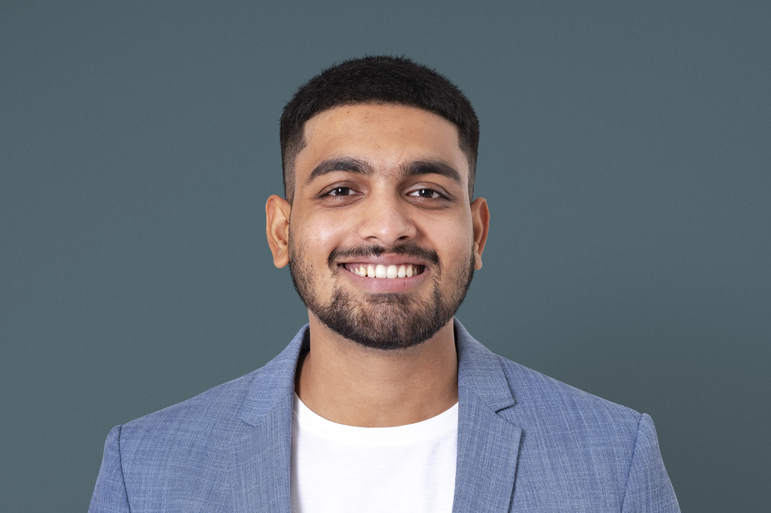 cheerful indian businessman smiling closeup portrait jobs career campaign scaled